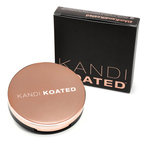 A view of a closed round rose-gold compact with the Kandi Koated logo on the lid beside its black and rose gold box.