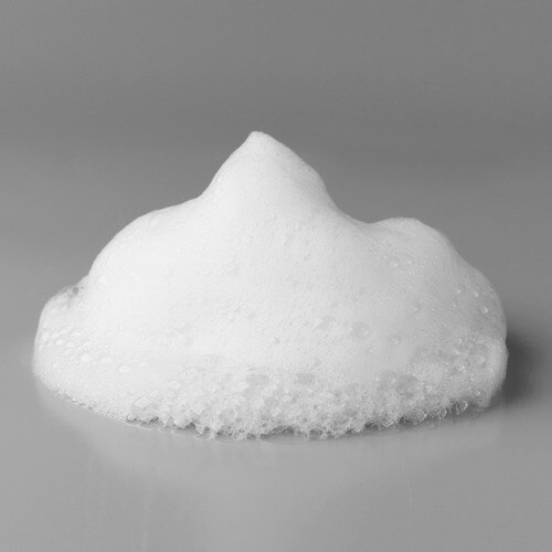 An image of a dollop of white foam from the FRESH foaming intimate wash on a light grey background.