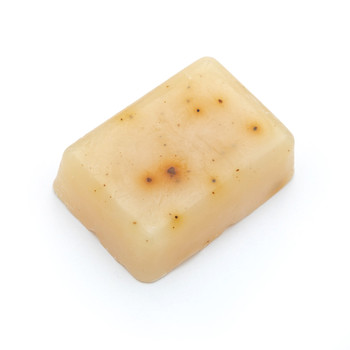An image of the herbal cleaning Balance Bar on a white background. The soap is rectangular and yellow with natural dark speckles and irregularities.