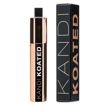 A rose gold DRAMA mascara tube and its black Kandi Koated box standing upright side by side on a white background.