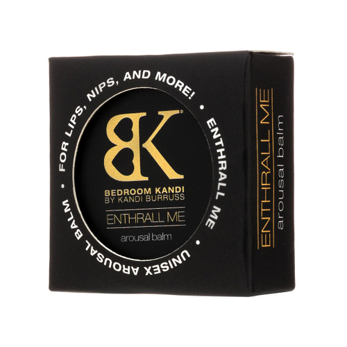A small square box with a round cut out window in the front revealing the label of the Enthrall Me arousal balm within. The box reads "for lips, nips and more" and "unisex arousal balm"