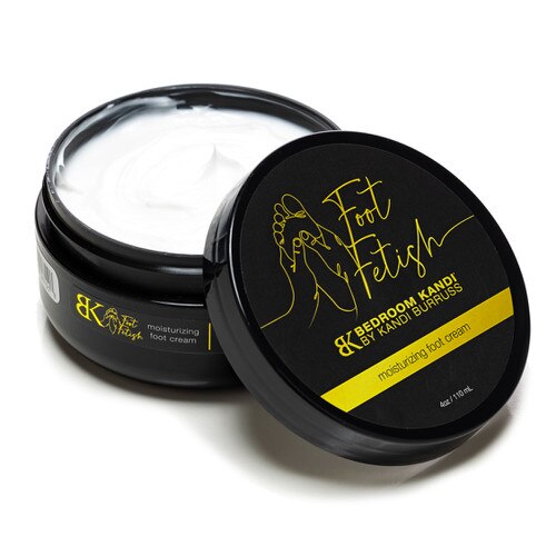 An open jar of the Bedroom Kandi Foot Fetish Moisturizing Foot Cream with the lid beside it.