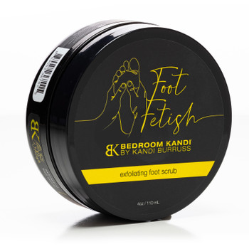 A closed black jar of Foot Fetish Exfoliating Foot Scrub by Bedroom Kandi on its side on a white background.