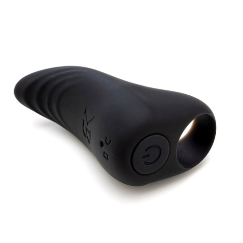 An angled view of the wearable Bedroom Kandi GET IN TOUCH finger vibrator, in black silicone, lying on its side on a white background. The power button is visible on bottom.