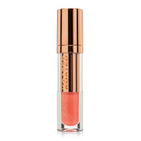 A closed clear and rose gold tube of Glaze lip shine in “Platonic”, a glittering light coral pink. The tube has Kandi Koated written up the side and a rose gold cap.