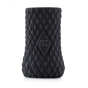 A front view of the black silicone cylindrical Helping Hand masturbation sleeve standing upright on its end. It is covered in a ridged diamond-pattern texture and emblazoned with the BK logo.