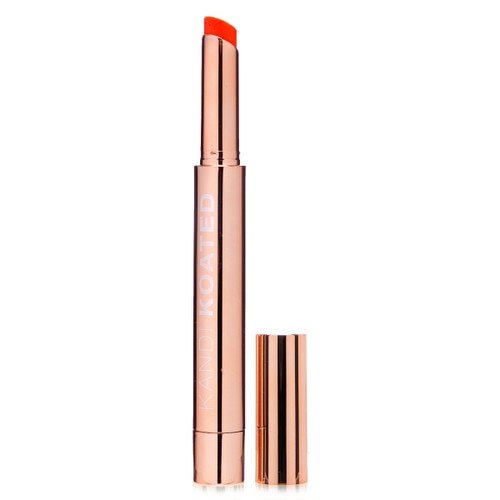 A rose gold tube and cap of Hint of Attitude tinted lip balm in Salty - a coral peach