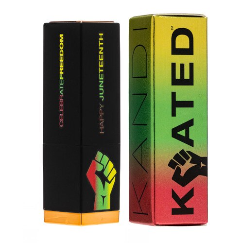 A closed tube of Juneteenth Special Edition Lipstick next to its packaging in red, gold, green and black