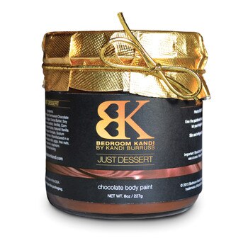A glass jar of Bedroom Kandi's Just Dessert chocolate body paint with gold foil wrapped around the lid.