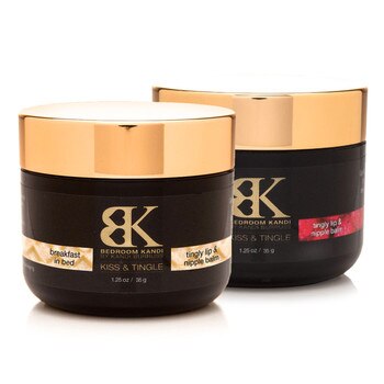 An image of two jars of Kiss & Tingle balm on a white background. The Breakfast in Bed flavor jar is positioned slightly to the front of the Raspberry flavor jar.
