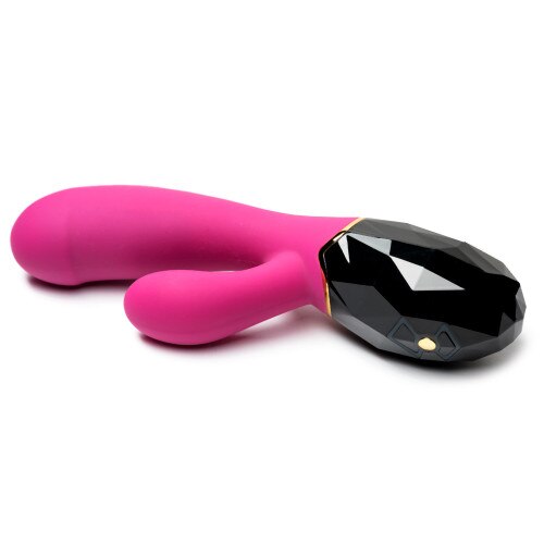 An image of Luxe Amaze lying on its side on a white background. The dual controls with different buttons to control the shaft or tickler motors are visible on the handle. The toy is pink and black.