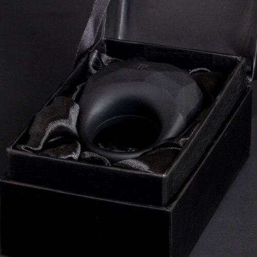 Luxe Embrace sitting in an open black satin-lined box on a black background. All Luxe toys come with sumptuous packaging.