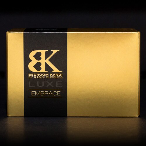 An image of the luxurious gold and black box that Embrace comes packaged in, sitting on a black background.