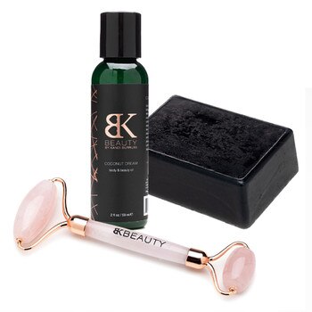 An image of Bedroom Kandi's Pure Body Bar, Face the Day Roller, and Coconut Dream oil arranged on a white background