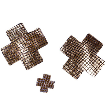An image of a pair of golden metallic snakeskin The Gold Standard cross-shaped Nippies for Bedroom Kandi with a patch test on a white background
