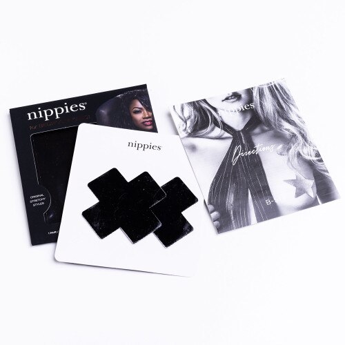 An image of the black patent cross nippies next to their packaging with instructions on a white background