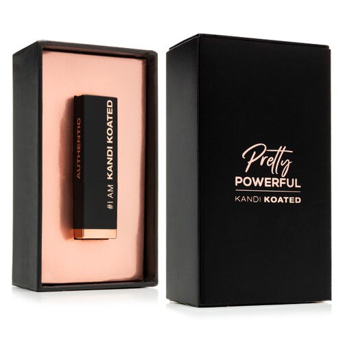 An image of the Pretty Powerful packaging. On the left is the open inside of the box with the lipstick tube sitting in a tray of rose gold. To the right is the black box lid with rose gold lettering