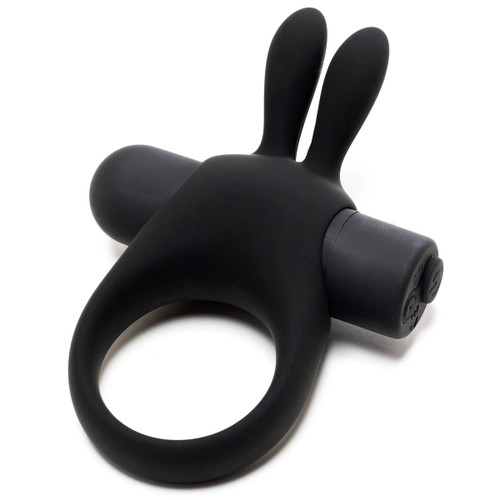 An angled view of the R and B vibrating couples ring, which has a rabbit-like 'face' shape and two tickler ears for pleasure and an elastic ring for shaft constriction