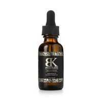 A small brown glass bottle of Rejuvenate Me restorative oil with a black and gold label and a dropper cap for easy application. It sits on a white background.