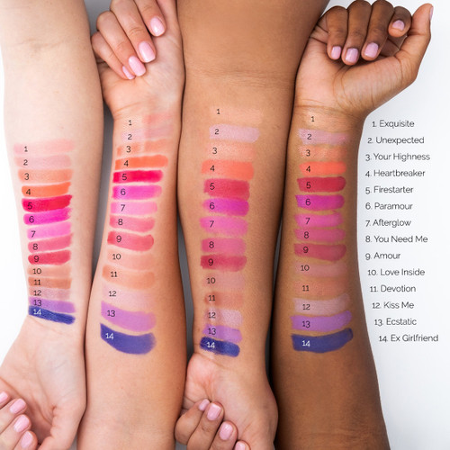 An image of four outstretched arms of differing skin tones showcasing 14 different colors of Satin lipstick in swatches on each arm for comparison.