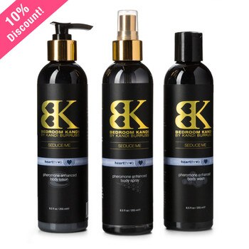 An image of three round-topped bottles of Seduce Me lotion, mist, and body wash in Heartthrob fragrance on a white background.