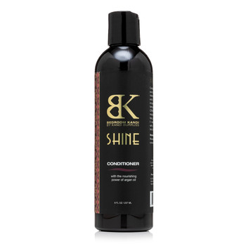 A black round-topped bottle of Bedroom Kandi's argan oil-infused Shine conditioner