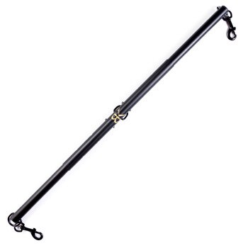 An image of the extended SPREAD DESIRE bondage spreader bar from Bedroom Kandi on a white background. There are clips on each end and a golden BK in the center of the black bar.