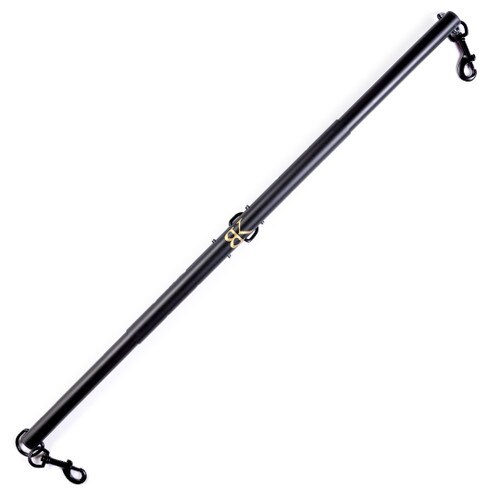 An image of the extended SPREAD DESIRE bondage spreader bar from Bedroom Kandi on a white background. There are clips on each end and a golden BK in the center of the black bar.