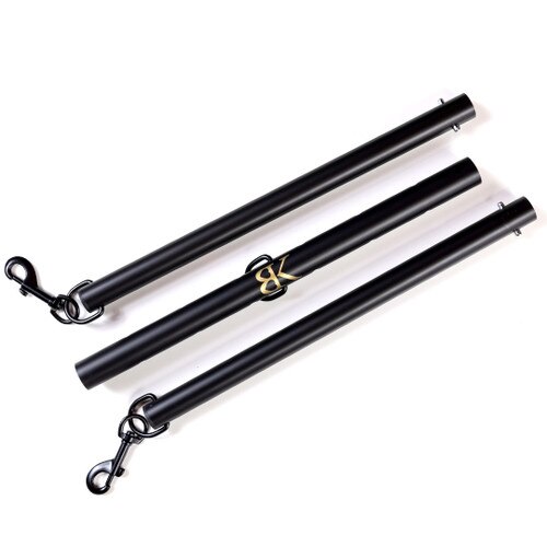 The SPREAD DESIRE positioning bar disassembled into three distinct pieces that fit together for the complete bar. The two end segments have clips and the center segment has a metal D ring.