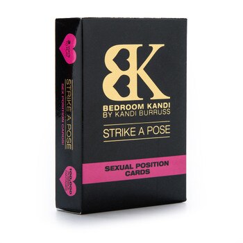 An upright box of Bedroom Kandi's Strike A Pose sex position cards deck. The box is black with gold and pink accents, and stands on a white background.