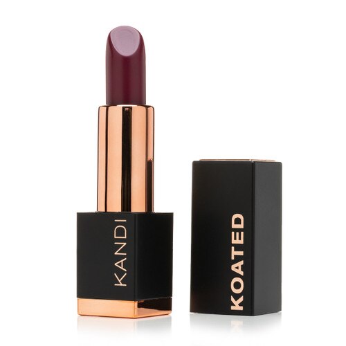 An image of a black and rose gold Suede lipstick tube with the cap standing beside it. The tube reads Kandi and the cap reads Koated. The color is Arousal, a rich wine red with purple tones.