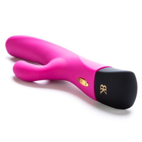 An angled view of Twice As Nice on its side, showing the on-off button, a gold button to toggle intensity, and the BK logo on the black end cap.