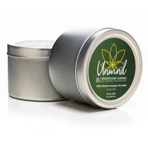 Two Unwind massage oil candles by Bedroom Kandi containing 30mg of CBD each, one on its side in front of the other on a white background