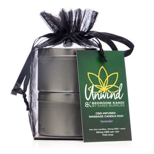 An image of the two tins of the Unwind CBD candle duo stacked on top of each other in a black organza bag with a tag