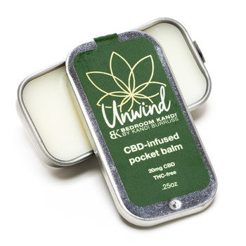 An open tin of the Unwind CBD-infused pocket balm for moisturizing and soothing lips, hands, and more.