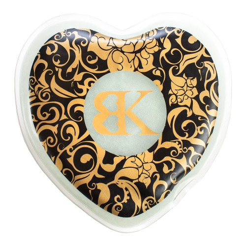 An image of a plastic heart-shaped flat sealed pouch printed with black and gold. Inside is a gelatinous material.