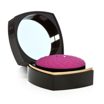 An image of the Make Me Over massager. The massage itself resembles a pink powder puff while the case it sits in resembles a black makeup compact, complete with mirror in the upper lid.