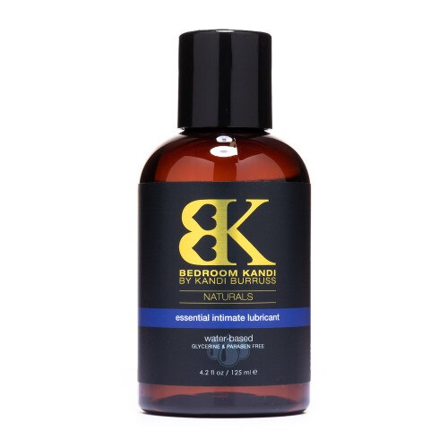 A bottle of Bedroom Kandi's Natural Essential Intimate Lubricant - a water-based lubricant in a brown bottle with a black cap on a white background